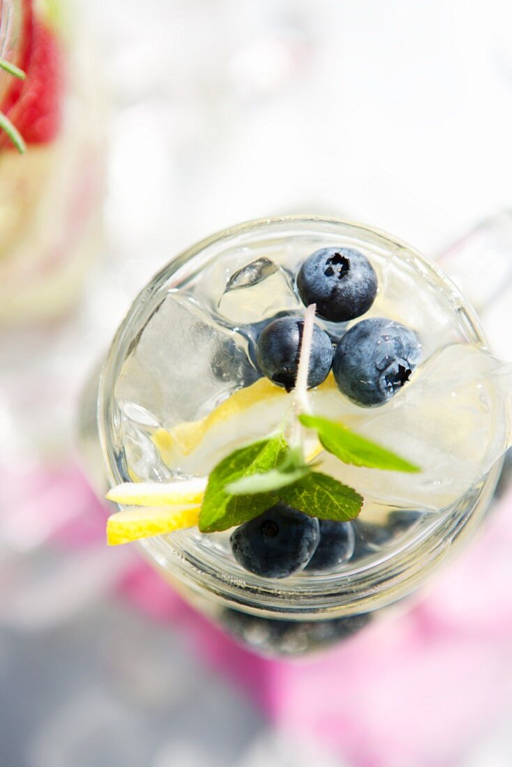 Blueberries, Lemon and Mint in a Mason Jar with Soda and Ice; From Above