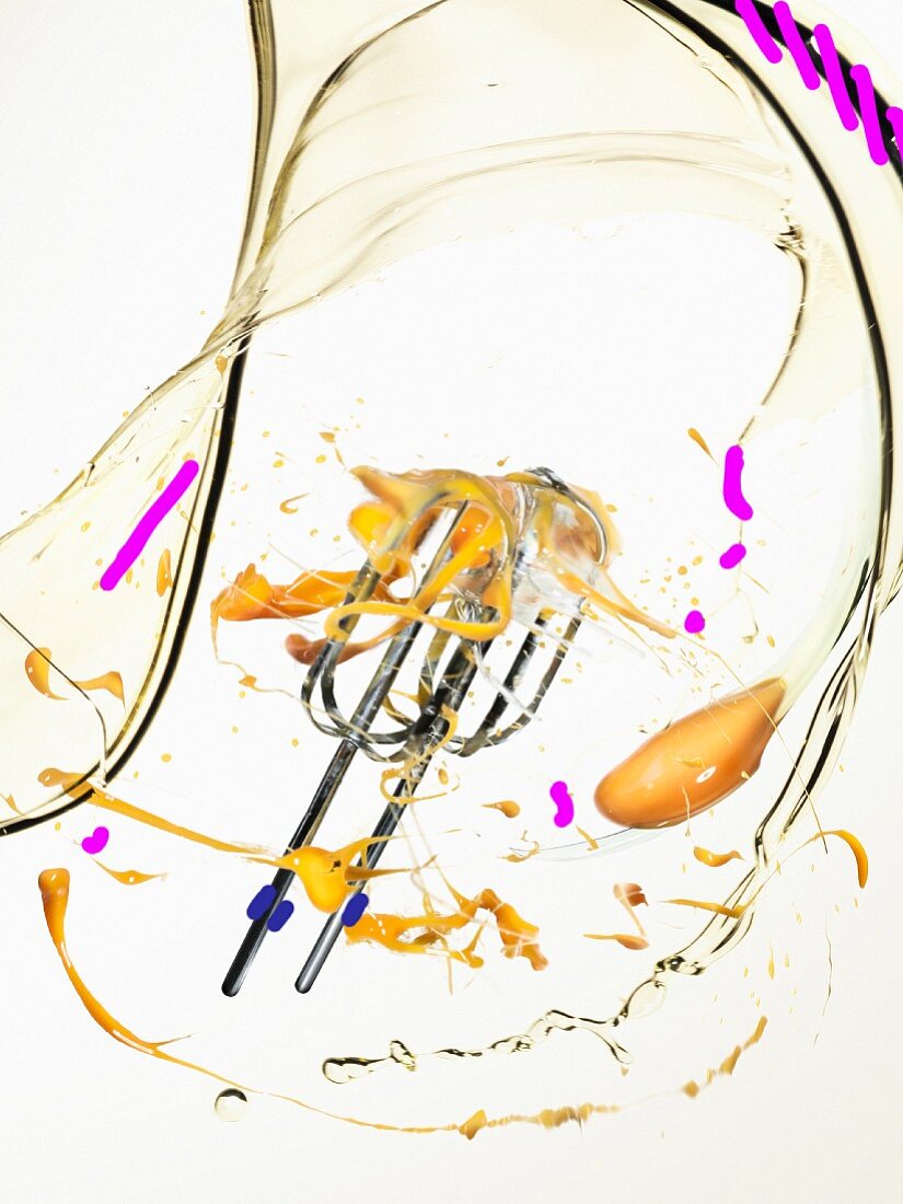 A whisk being cleaned in water after making mayonnaise
