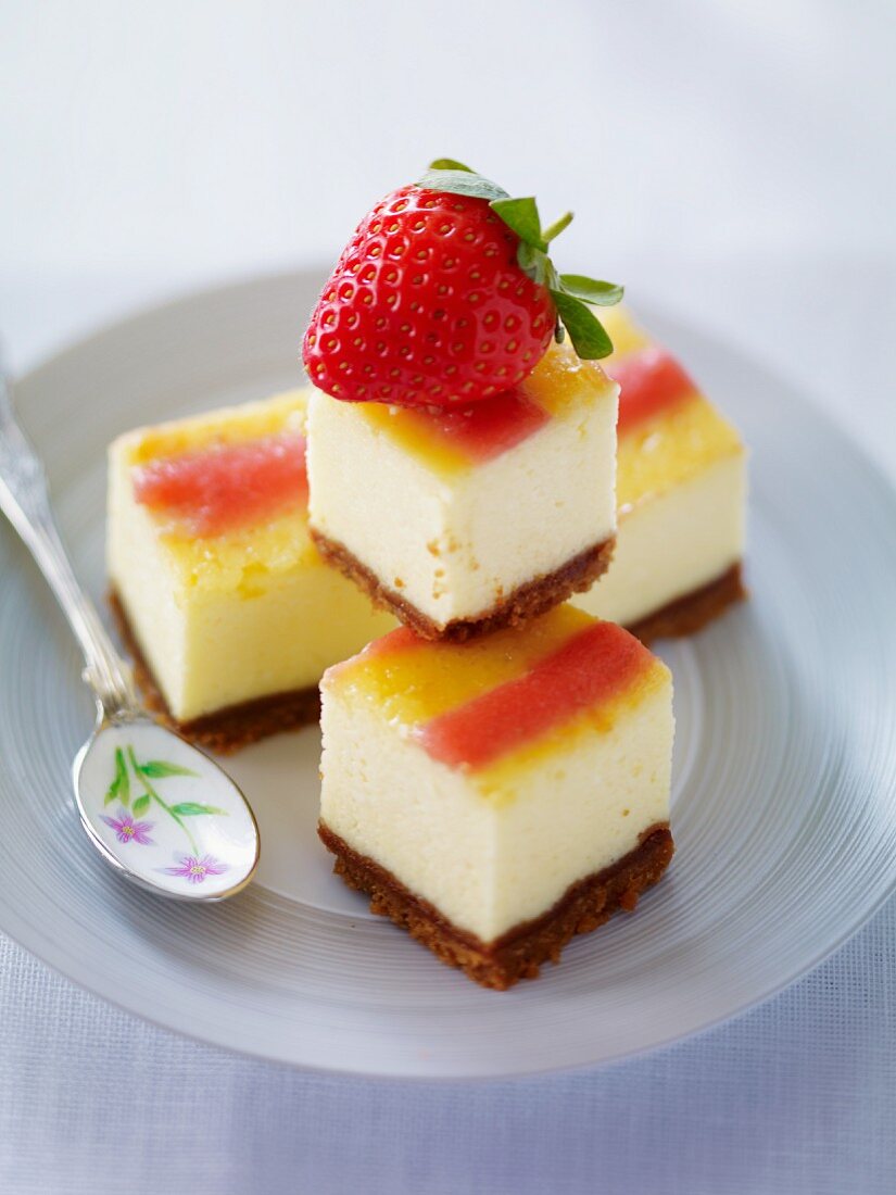Cheesecake cubes garnished with a strawberry