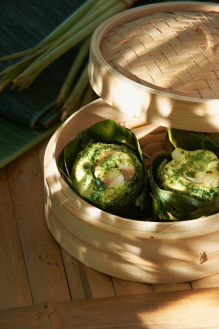 Cod and coconut pies in a bamboo steamer (Asia)