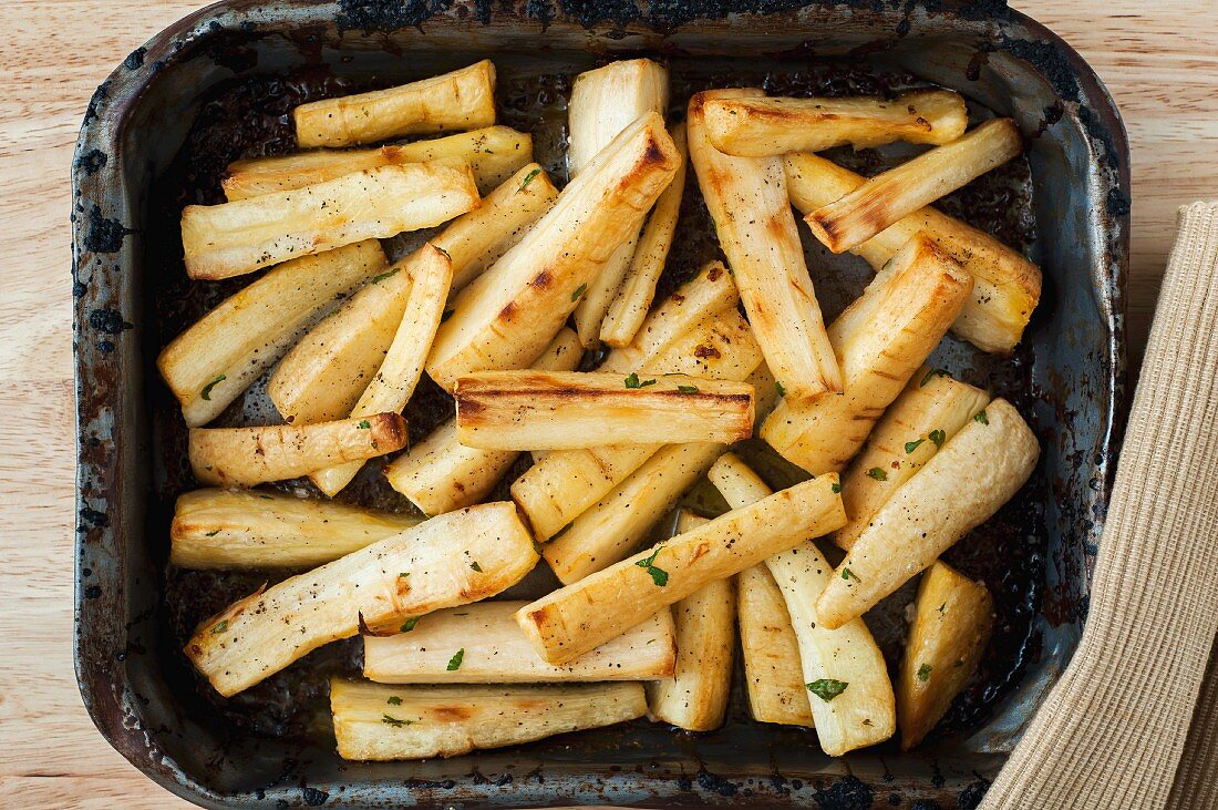 Roast parsnips in an old roasting tin