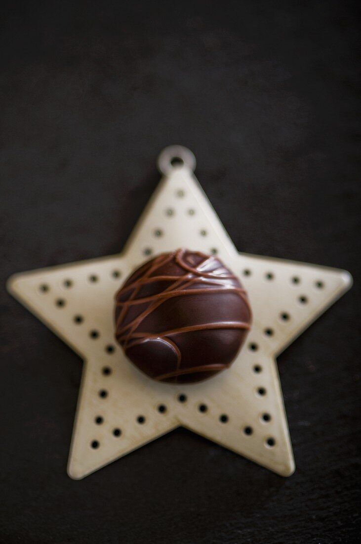 A chocolate praline on a Christmas star
