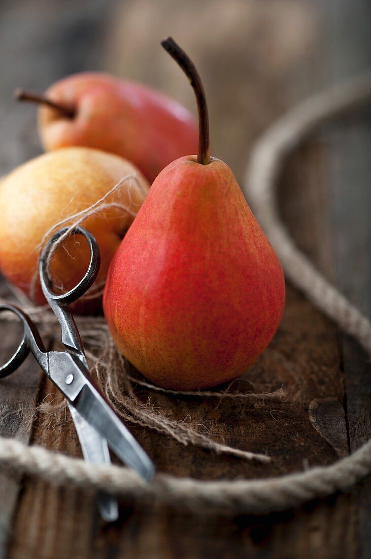 Red pears with string and scissors