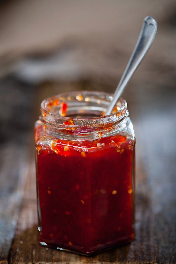 A jar of jam with a spoon