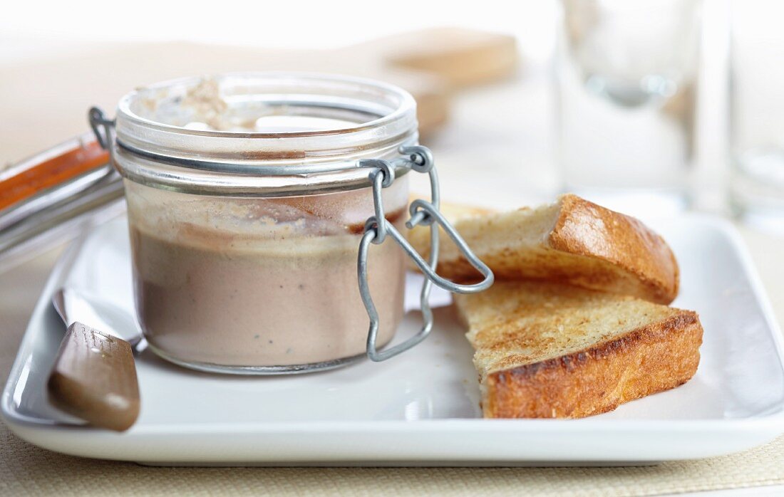 Open Jar of Homemade Duck and Mushroom Pate with Toasted Bread