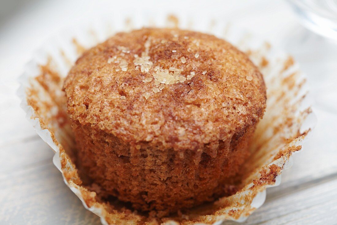 A Cinnamon Sugar Muffin with Wrapper Peeled Away