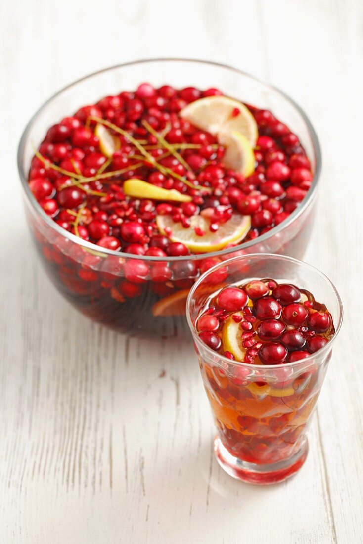 Punch with rum, beer, cranberries, redcurrants and lemon