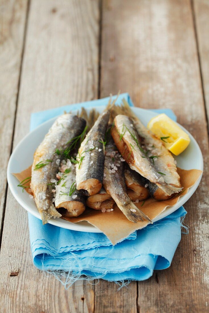 Fried herring with salt and lemon