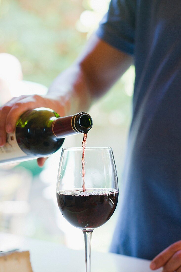 Man pouring glass of red wine