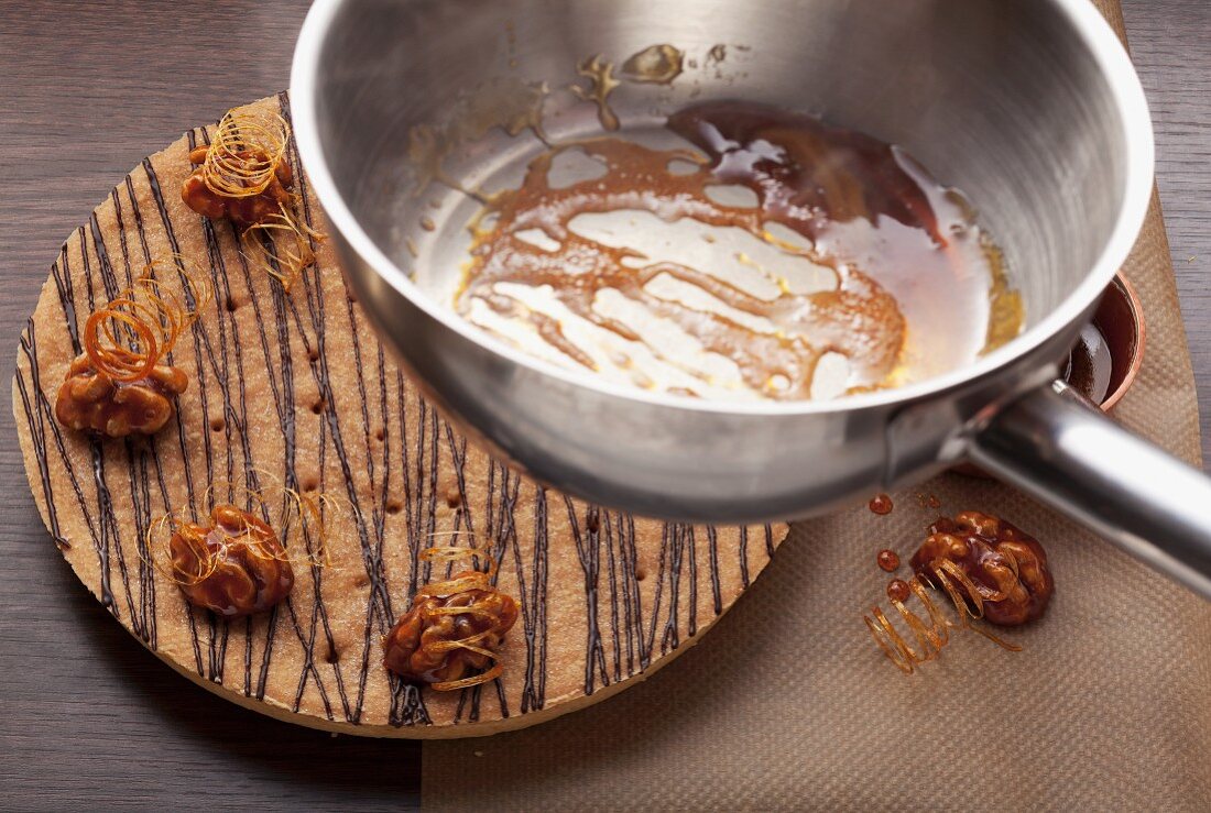 A walnut cake and a pan with caramel in