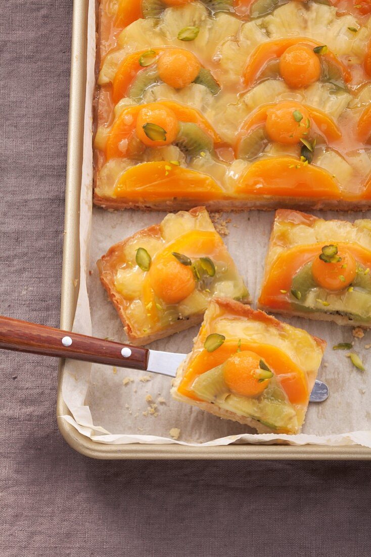 Fruit-topped cake in a baking tin