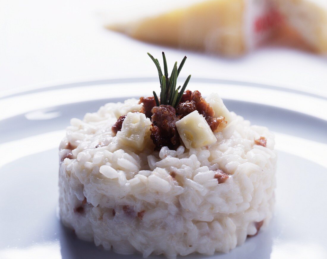 Risotto al panerone (cheese risotto with sasiccia and cubes of cheese)