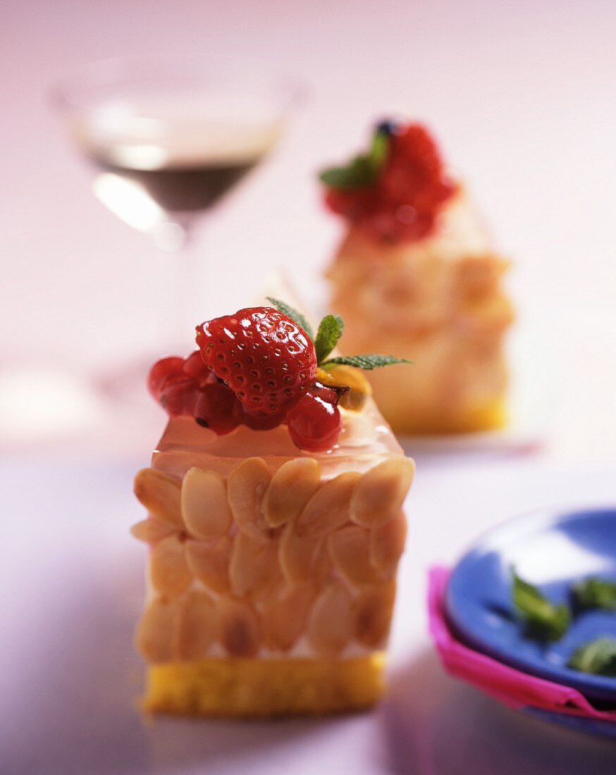 Almond gateau with berries, served with a glass of dessert wine
