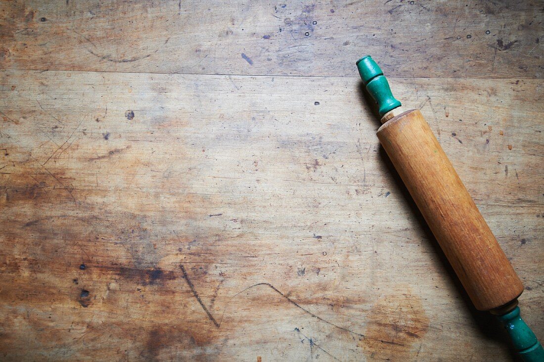 A Rolling Pin on a Wooden Table; From Above