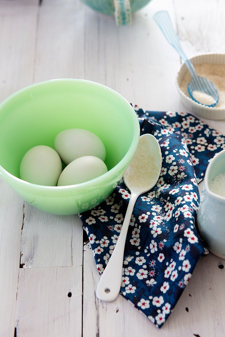 Three Eggs in a Green Bowl; Spoon, Sugar and Cream