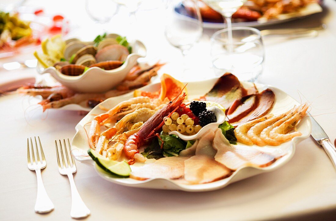 A plate of mixed starters with prawns, langoustines, and carpaccio of tuna and of swordfish