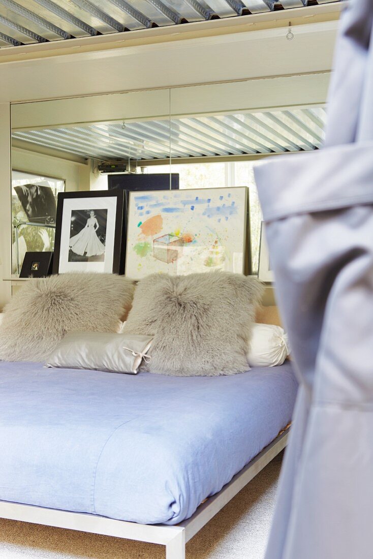 Pillows on a bed in the bedroom with corrugated iron lining