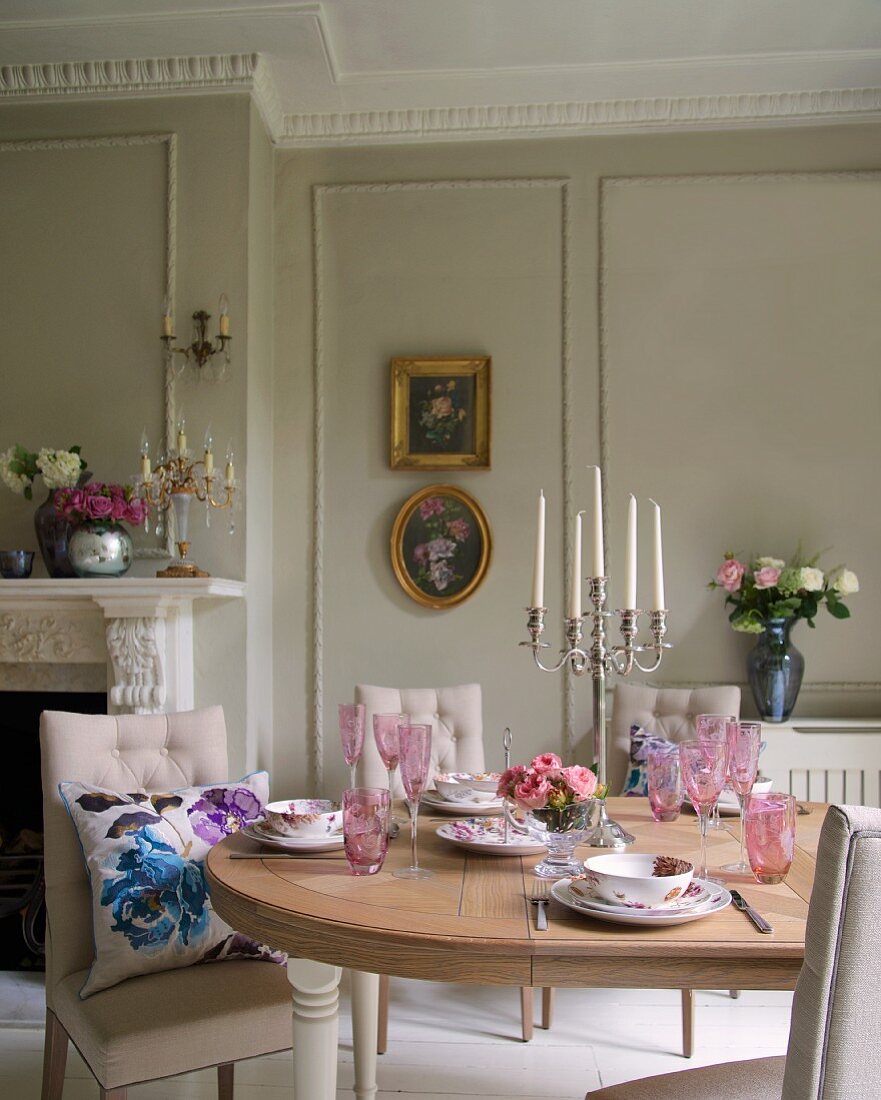 Dining table and upholstered chairs in front of fireplace