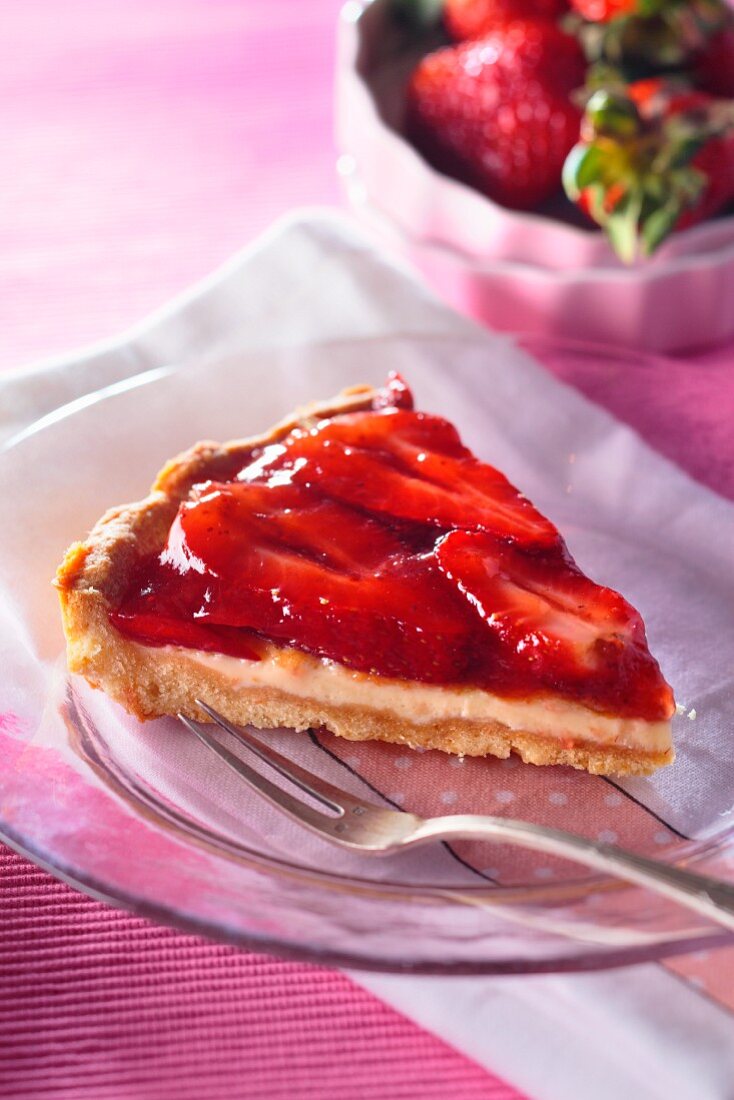 A slice of strawberry flan with vanilla crème