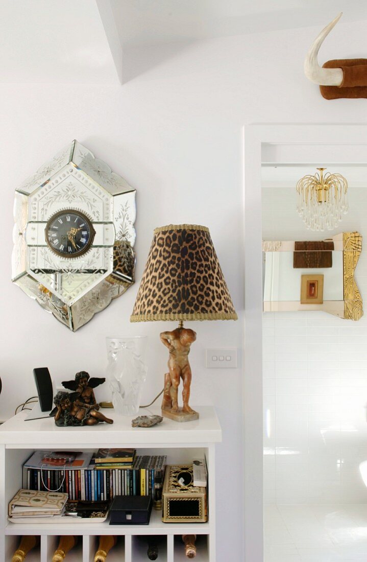 Postmodern wall clock and table lamp with leopard-print lampshade on small set of shelves