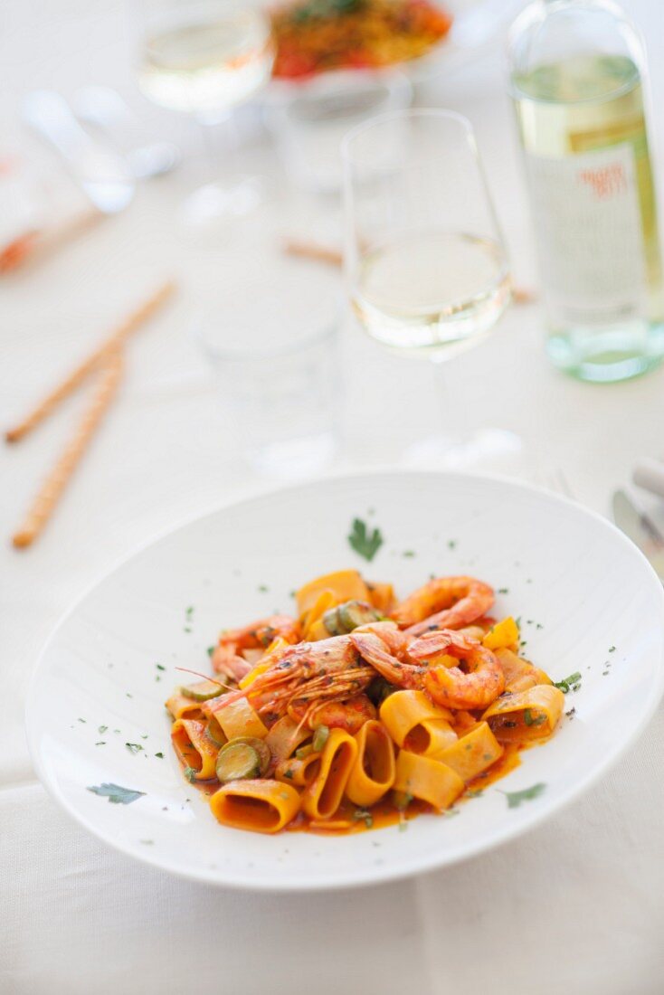 Pasta calamarata (pasta with prawns, tomato sauce and courgette)