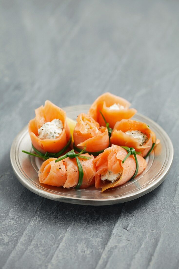 Rolls of smoked salmon filled with cream cheese with herbs