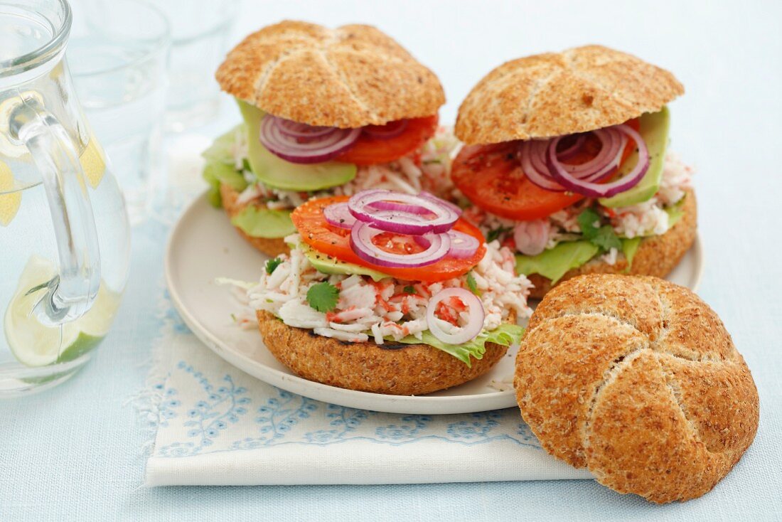 Home-made burgers with surimi salad, tomato, lettuce and red onion