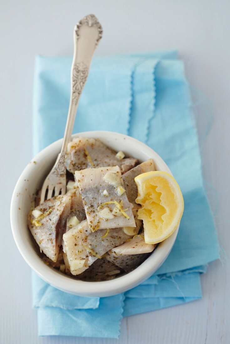 Pickled herring with garlic, lemon and marjoram