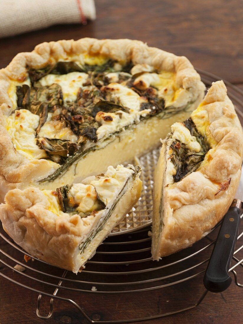 Spinach and Goat Cheese Quiche; Sliced on a Cooling Rack
