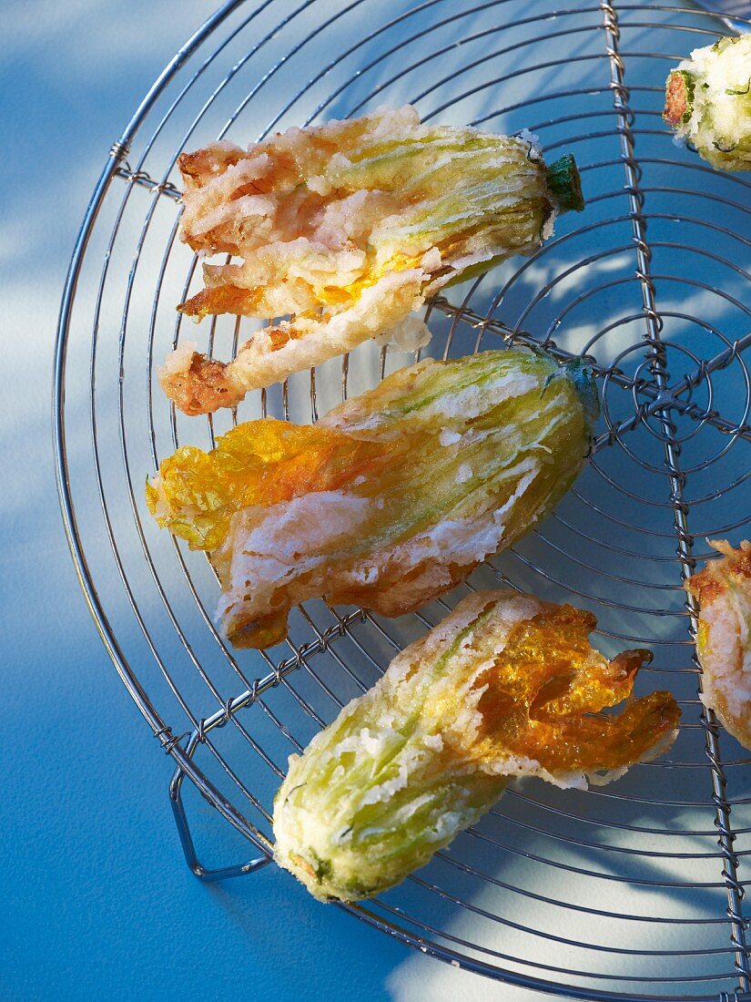 Deep-fried courgette flowers on a rack