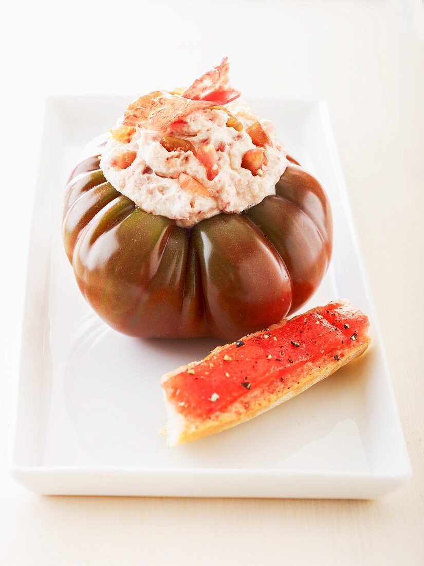 Tomato stuffed with ham mousse