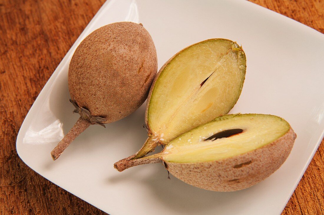 Sapodilla Fruit; One Sliced Open and One Whole