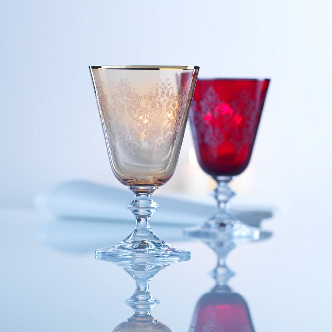 Two coloured cut-glass wine goblets
