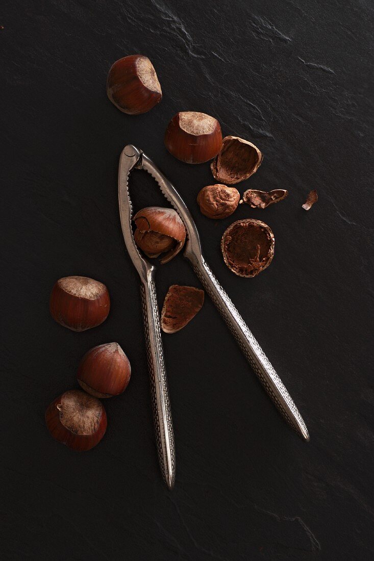 Hazelnuts with a nutcracker on a slate