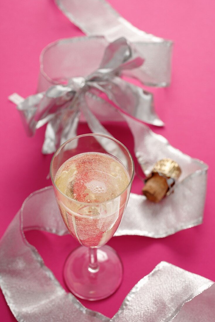 Champagne glass, champagne cork and ribbon