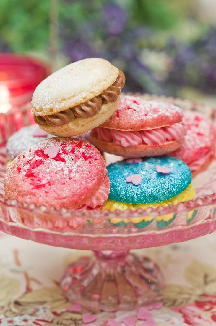 Macaroons filled with buttercream on a cake stand