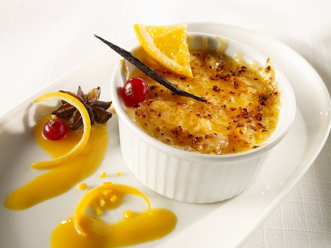 Crème brulée with orange, redcurrants and star anise