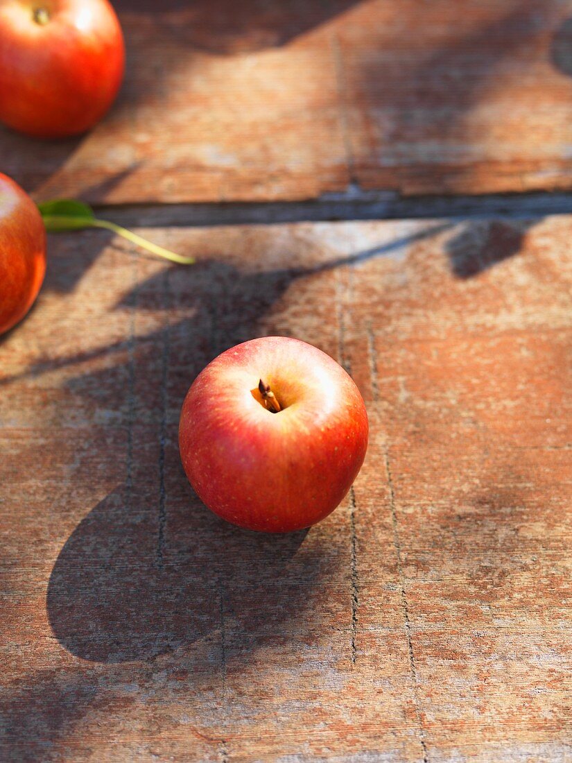 An Organic Fuji Apple on Wood