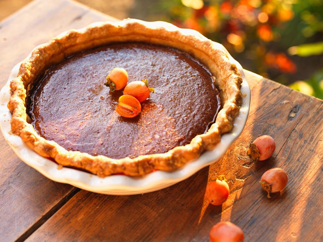 A Whole Persimmon Pie on a Wooden Table