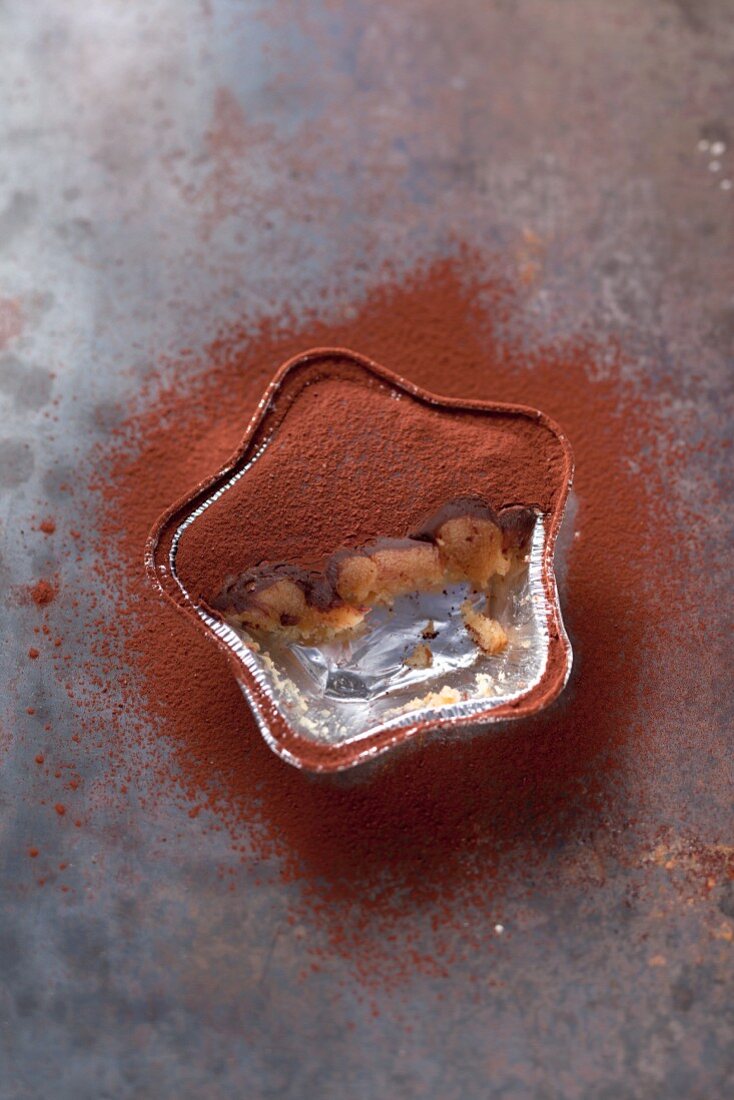 A half-eaten individual chocolate and toffee cake in the shape of a star