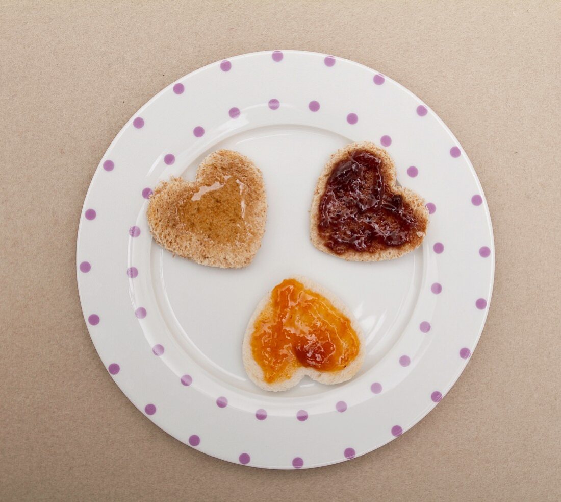 Hearts cut out of bread, with jam and honey, for Valentine's Day