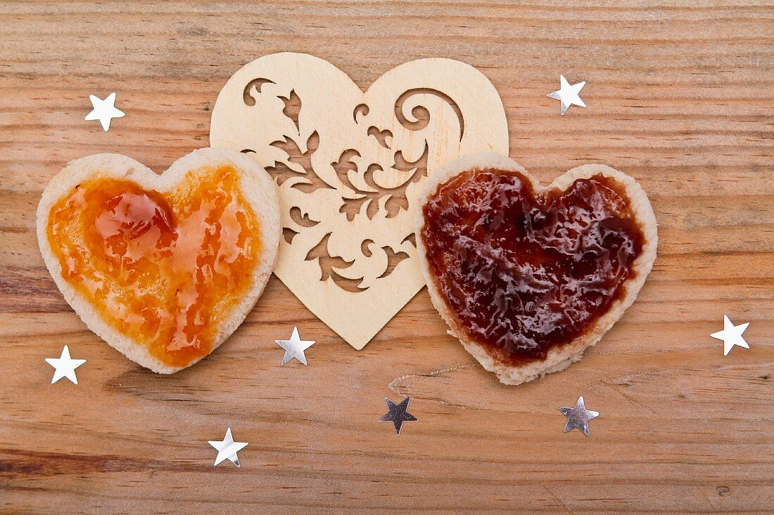 Hearts cut out of bread, topped with jam, for Valentine's Day