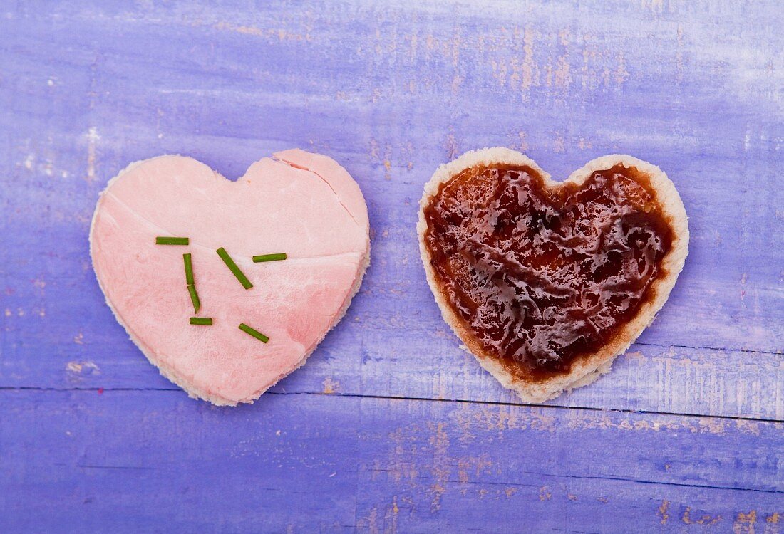 Two hearts cut out of bread, one with ham and one with jam, for Valentine's Day