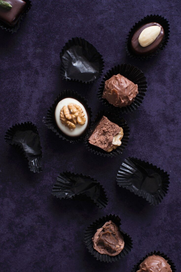 An assortment of filled chocolates and empty chocolate cases