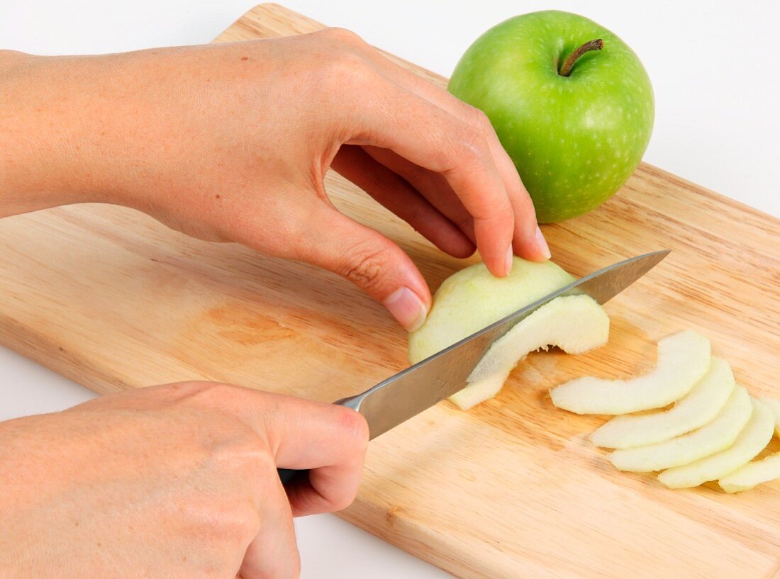 A green apple being sliced