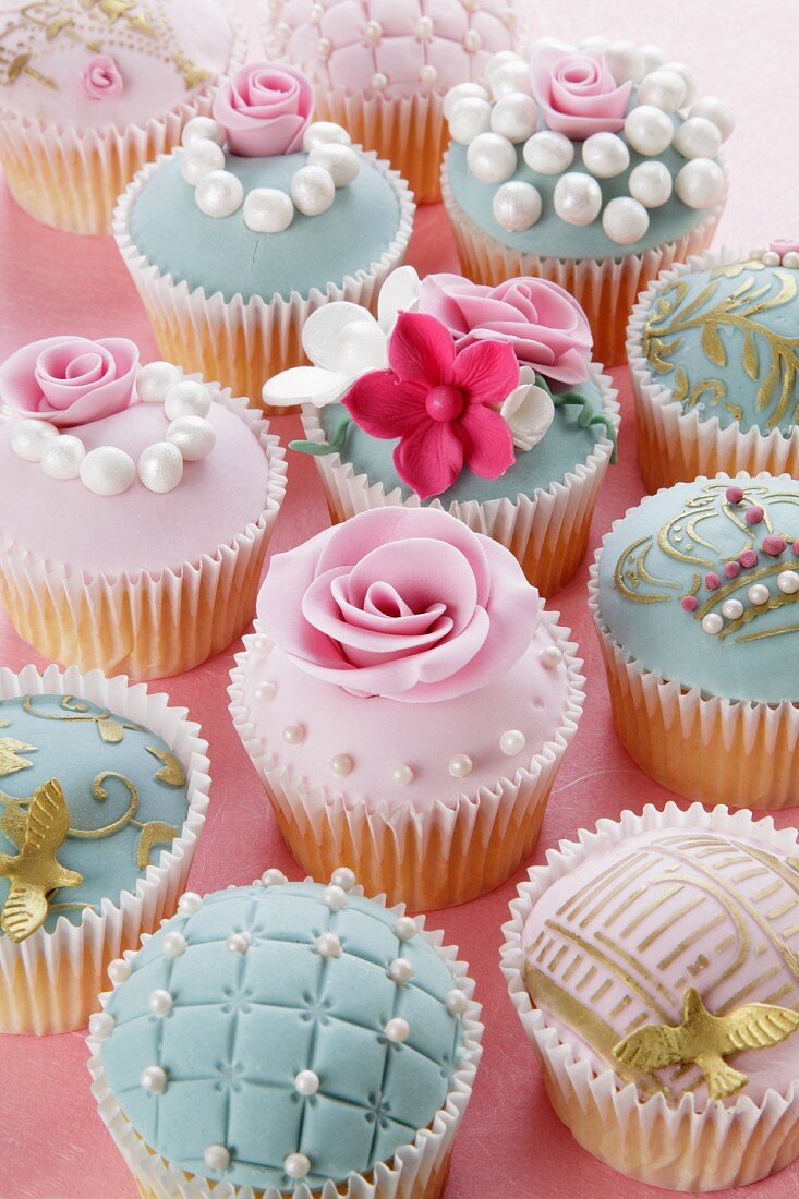 Assorted celebration cupcakes decorated with sugar roses and sugar pearls