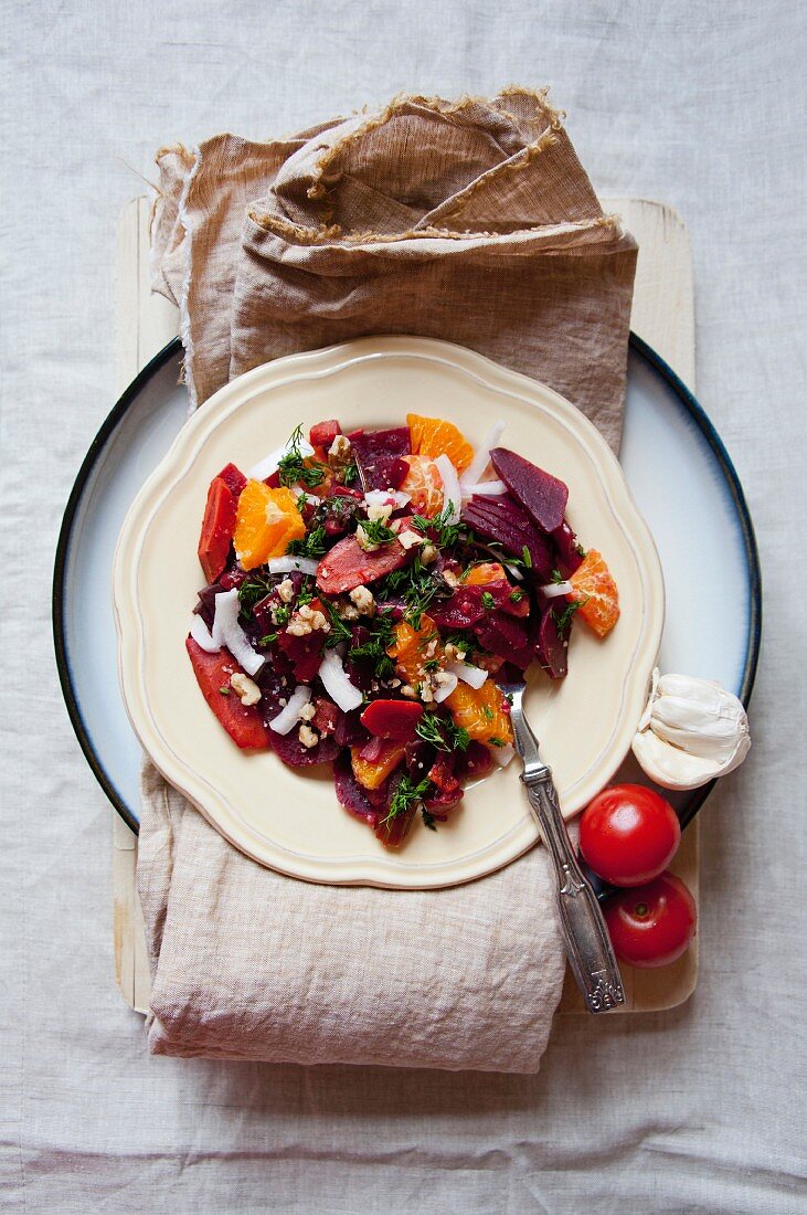 A salad of fish, tomatoes, beetroot and mandarins