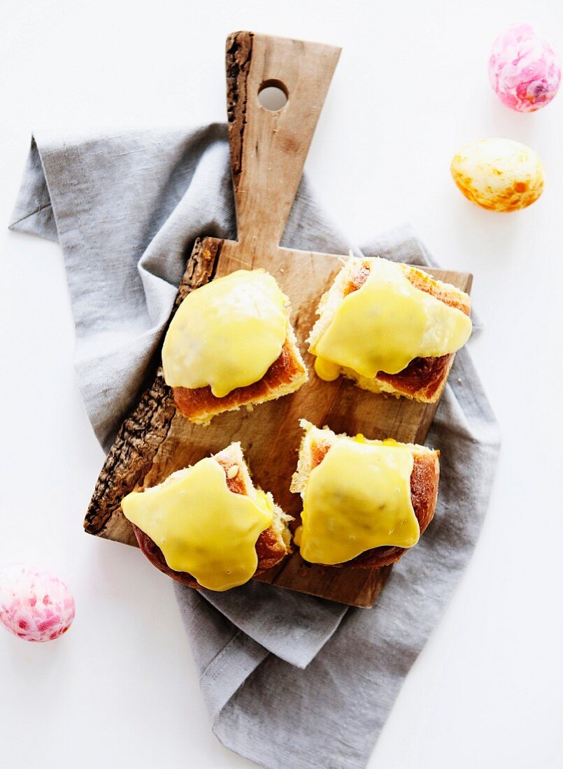 Toasted sandwiches topped with cheese on a chopping board, and sugar eggs