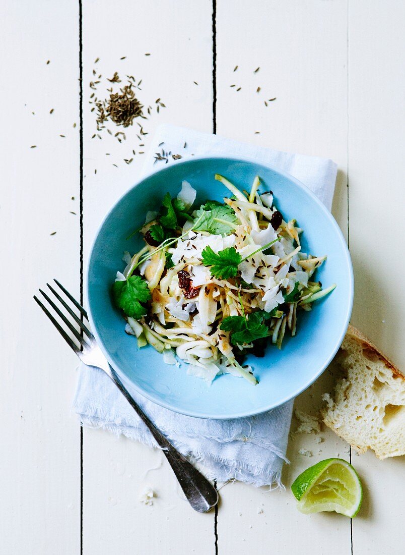Sprout salad with cheese and coriander leaves, with a lime and some white bread