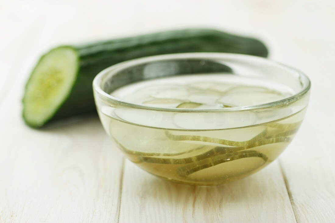 Half a cucumber and a dish of pickled cucumber slices